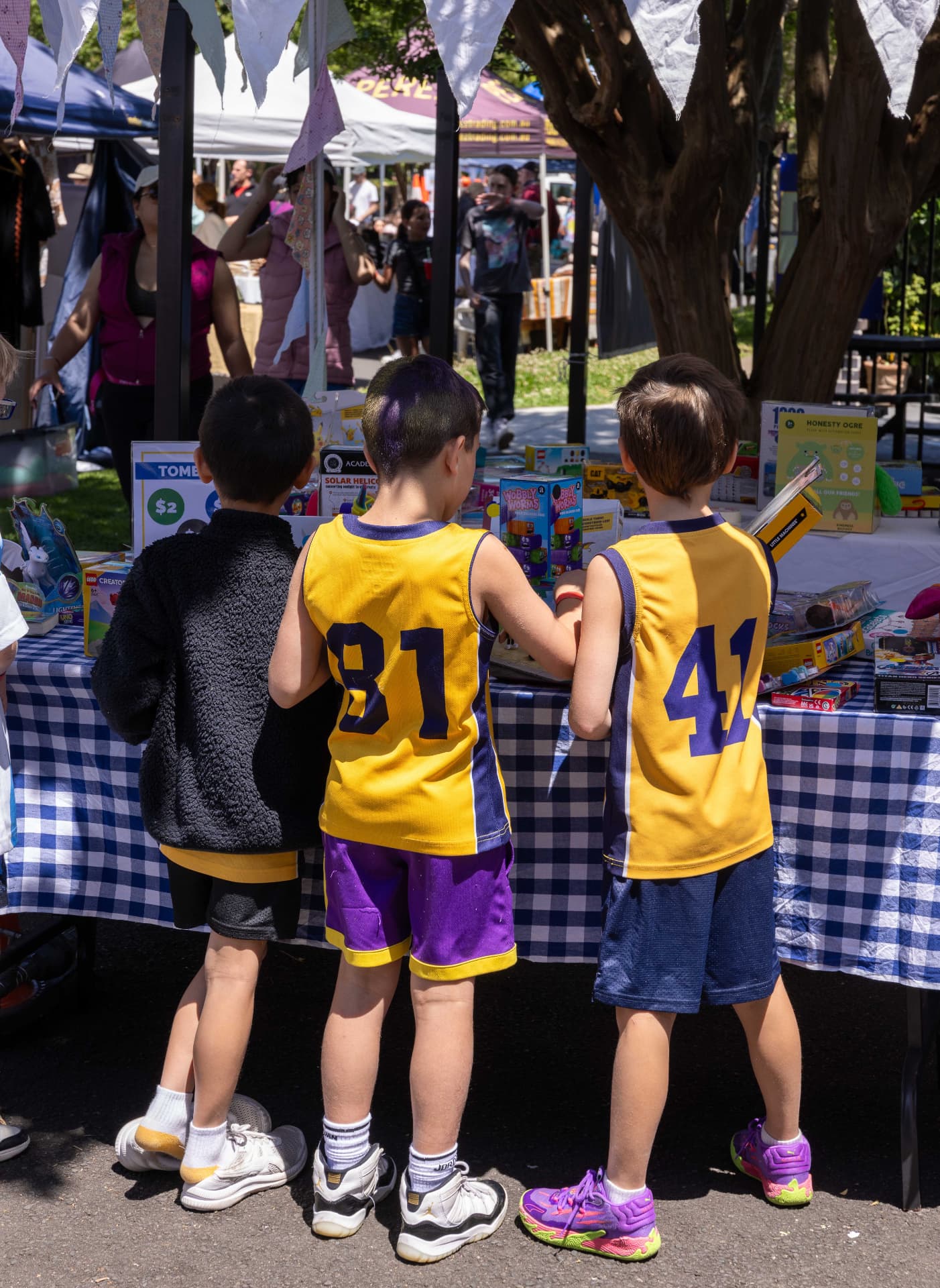 Children browsing toys and games at a St Thomas market stall