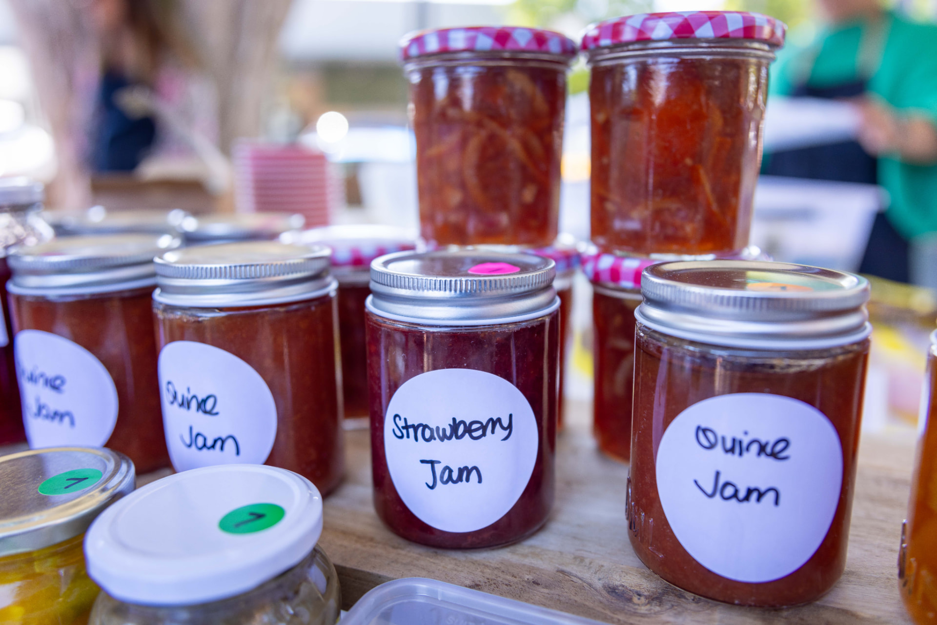Jars of homemade strawberry and quince jam for sale