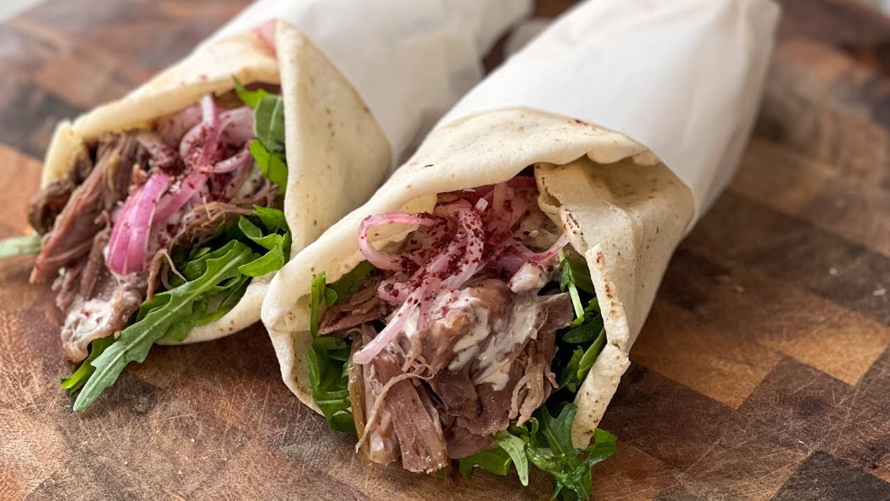 Fresh slow-cooked lamb wraps with greens